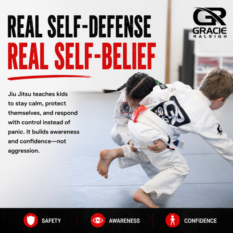Two children practicing a safe martial arts takedown and self-defense technique on the mats at Gracie Raleigh.